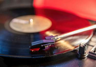 Record player with a vinyl inside being played.