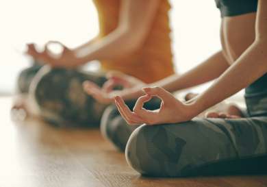 Two people doing yoga.