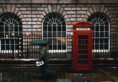 Telephone box on a rainy street.