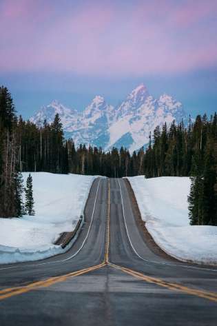 Jackson hole road leading to mountains.