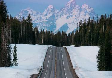 Jackson hole road leading to mountains.