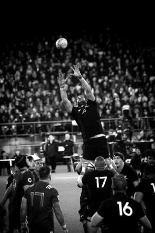 Black and white picture of rugby in action.