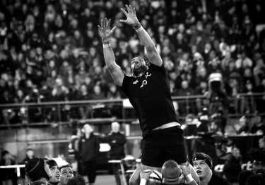 Black and white picture of rugby in action.