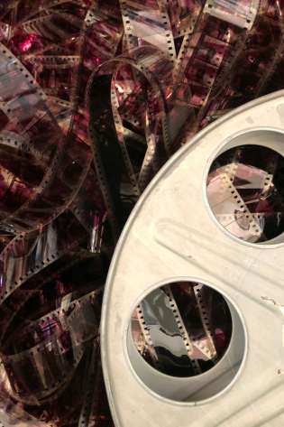 Unravelled reddish purple film roll.