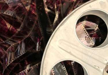 Unravelled reddish purple film roll.