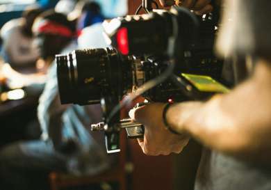 Large film camera with a blurry background.