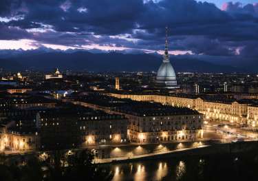 Torino, Italy lit up at dusk.