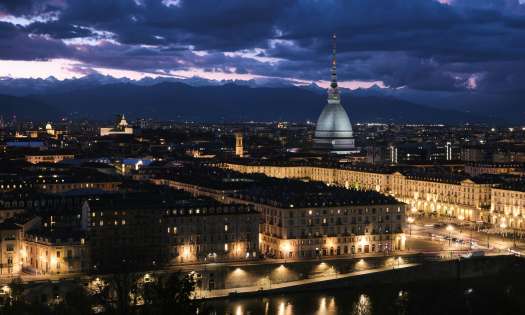 Torino, Italy lit up at dusk.