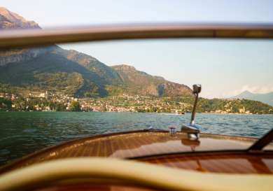 View from a speedboat looking across lake como.