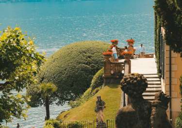 Side view of villa in lake como with statue .