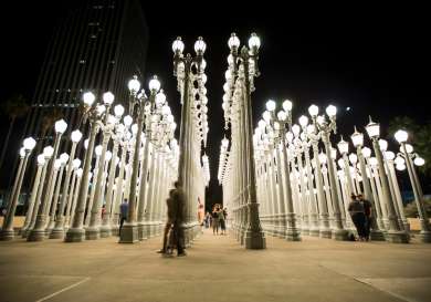 Lots of rows of street lights all together at night.