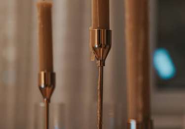 Three candles on dining table.