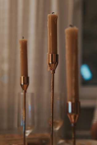 Three candles on dining table.