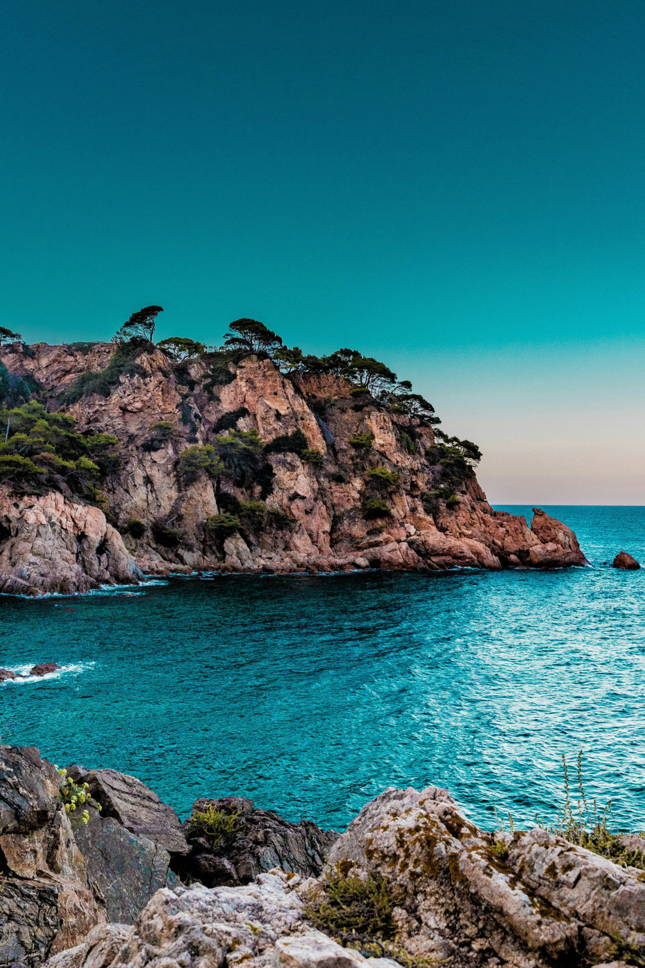 photo of marbella sea with rocky surroundings