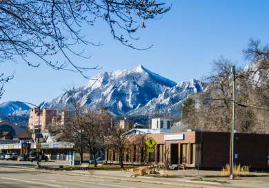 Town with showy mountains behind in Boulder, Colorado.