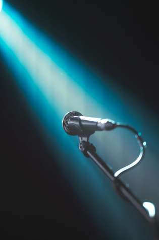 Microphone with turquoise light beam.