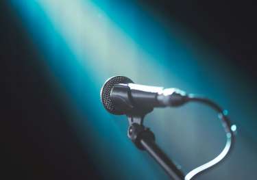 Microphone with turquoise light beam.