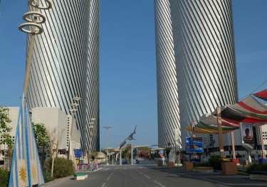 Large metal buildings on either side of a road.