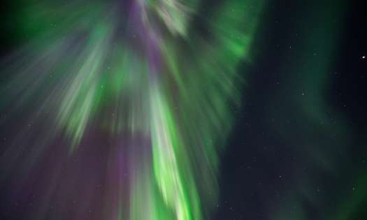 Photo of night sky with northern lights .