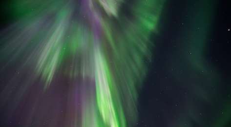Photo of night sky with northern lights .