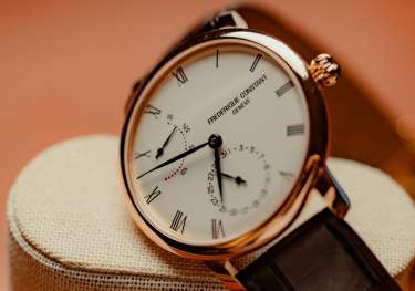 A close up of a luxury rose gold wristwatch.