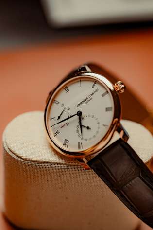 A close up of a luxury rose gold wristwatch.