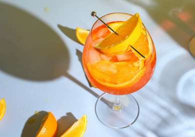 Orange cocktail with orange segment.