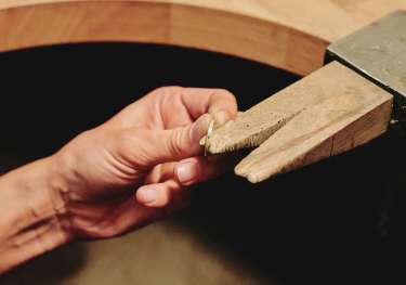 Person making ring in workshop.