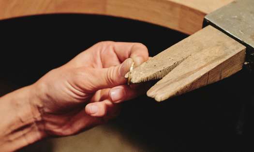 Person making ring in workshop.