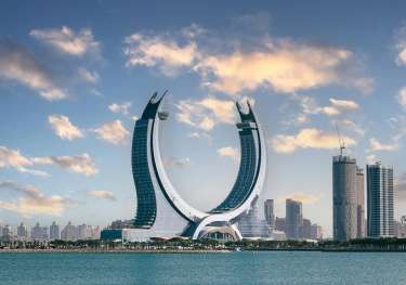 Horseshoe shaped monument behind a body of water.