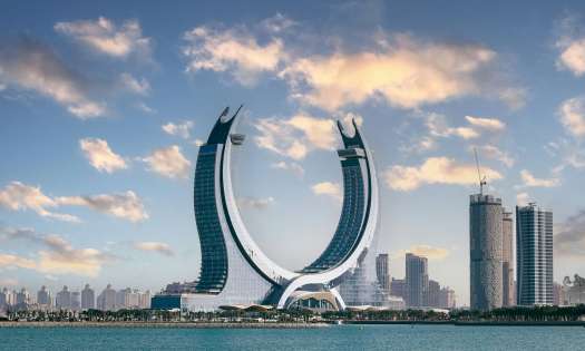 Horseshoe shaped monument behind a body of water.