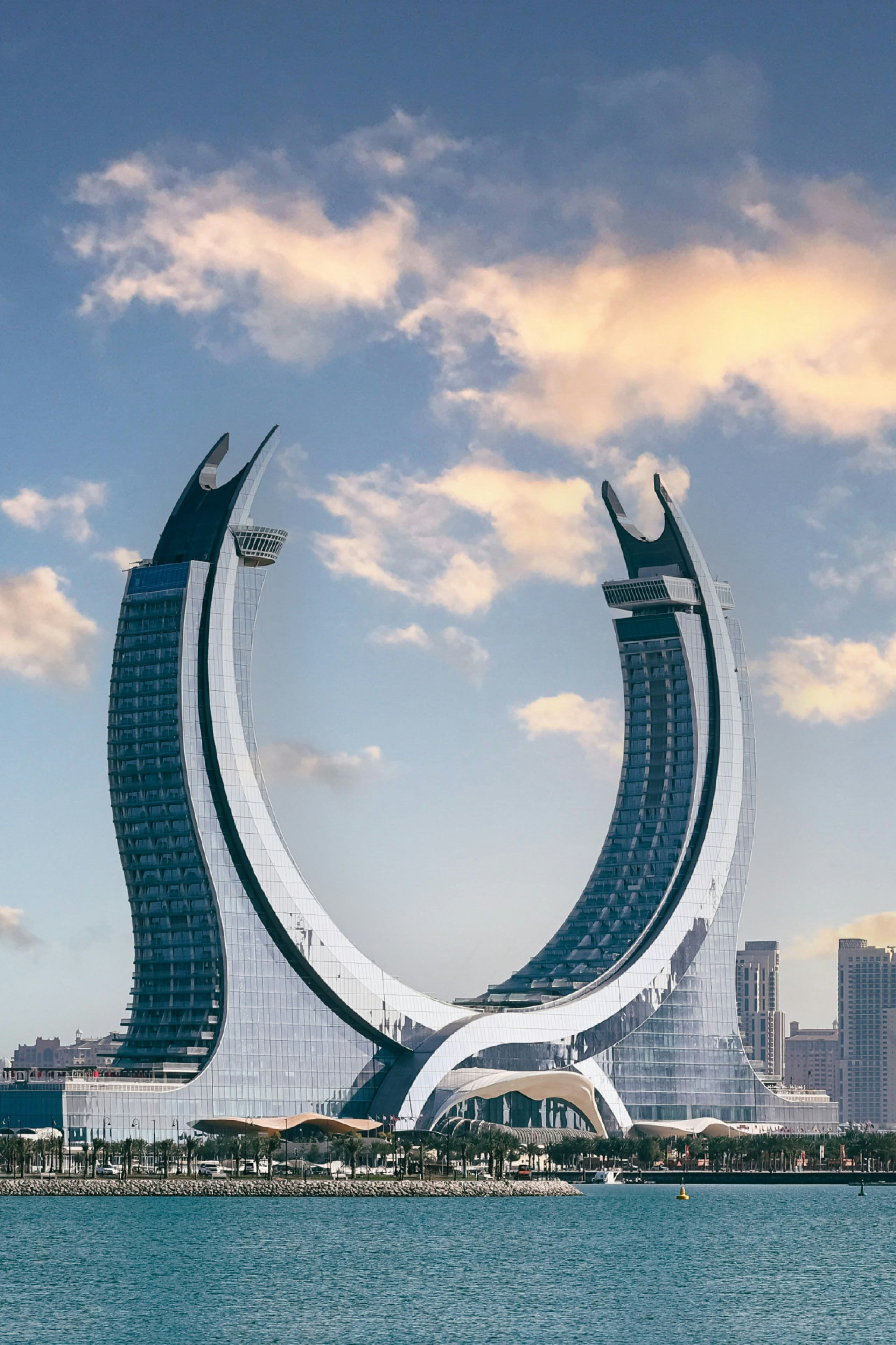 Horseshoe shaped monument behind a body of water