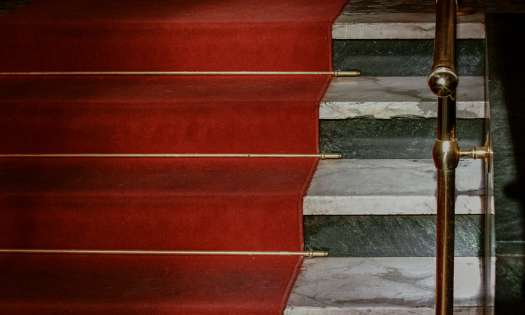 Red carpet on marble stairs.