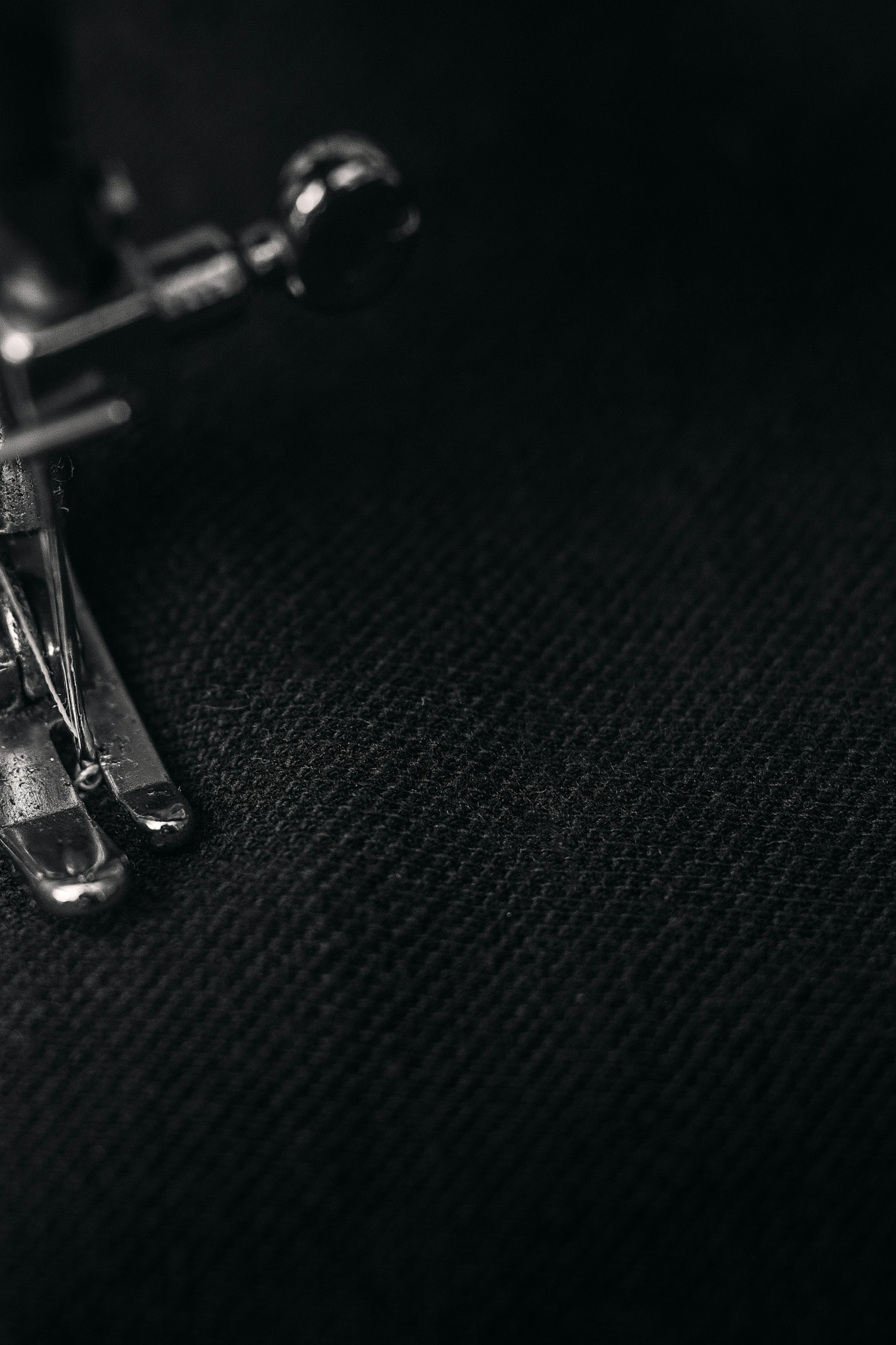 sewing machine stitching on black fabric
