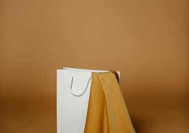 White shopping bag containing silky fabric .