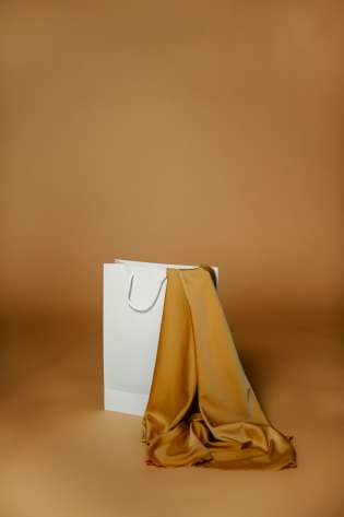 White shopping bag containing silky fabric .