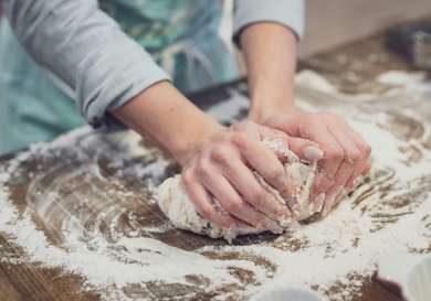 Person kneading dough.