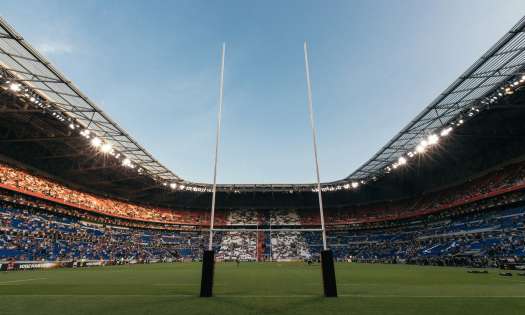 Stadium with a rugby field and post.