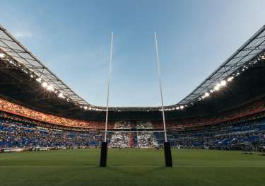Stadium with a rugby field and post.