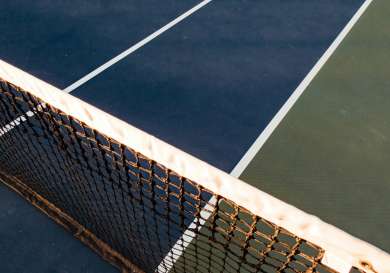 Blue and green tennis court with the net.