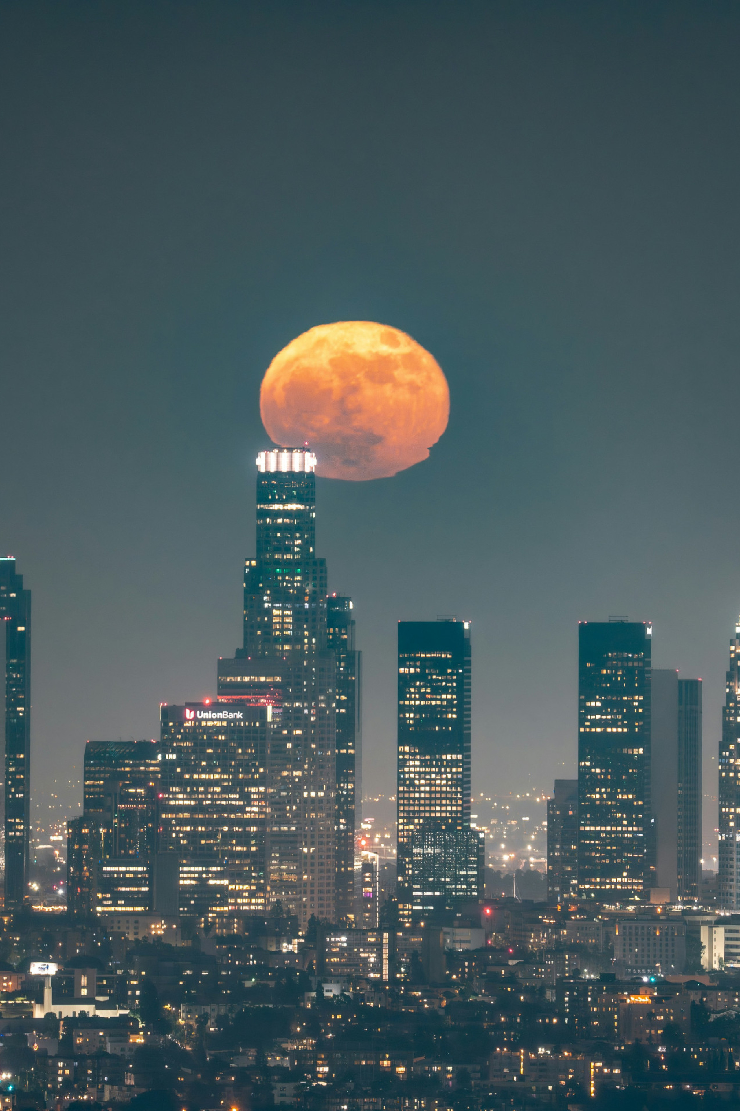 Las Angeles skyline at night with a large and beautiful moon