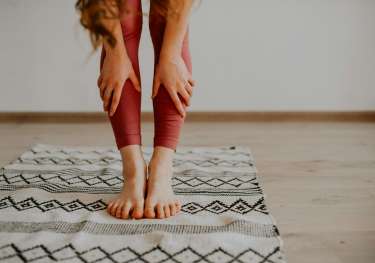 Woman stretching on mat.