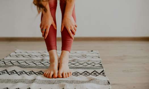 Woman stretching on mat.