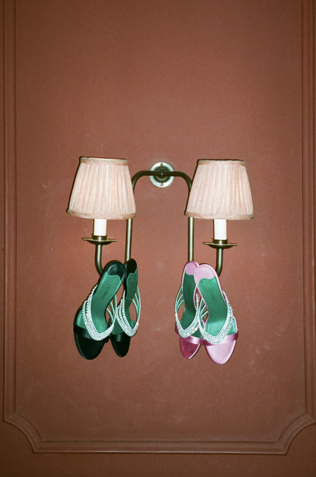 two heels hanging from wall lights 