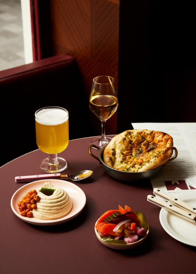 mix of restaurant dishes and drinks on table at restaurant 
