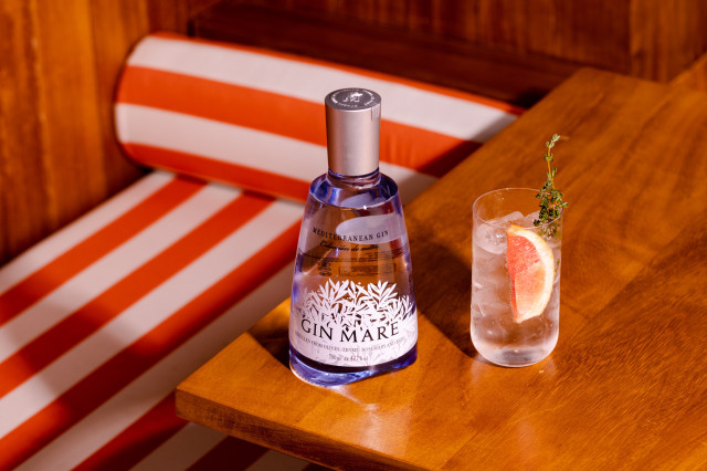 gin cocktail with slice of grapefruit and herbs