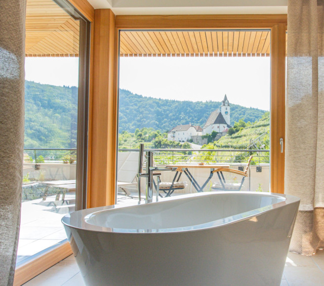 hotel bathroom with views of hills