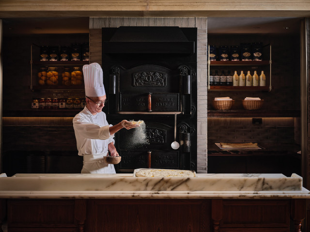chef making bread inside hotel restaurant 