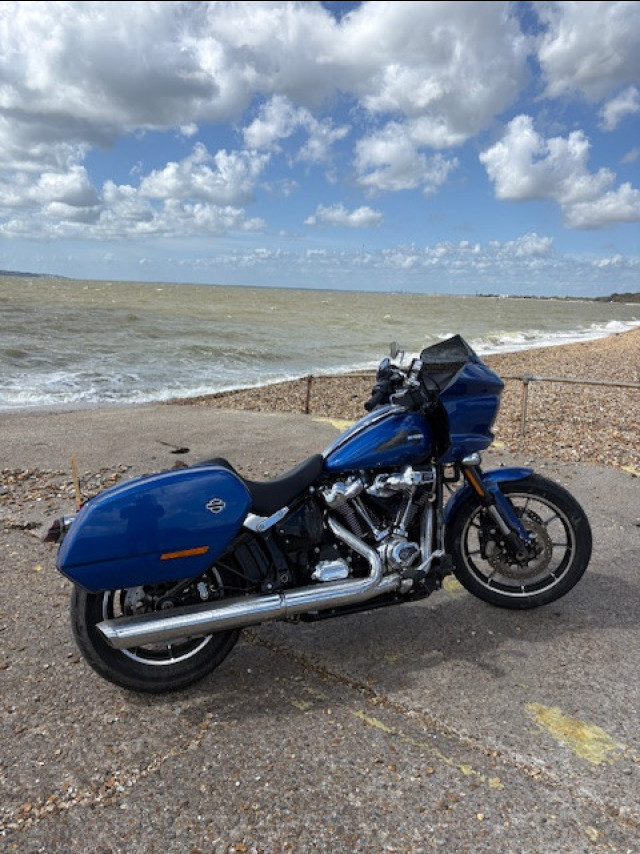 harley davidson bike parked by sea