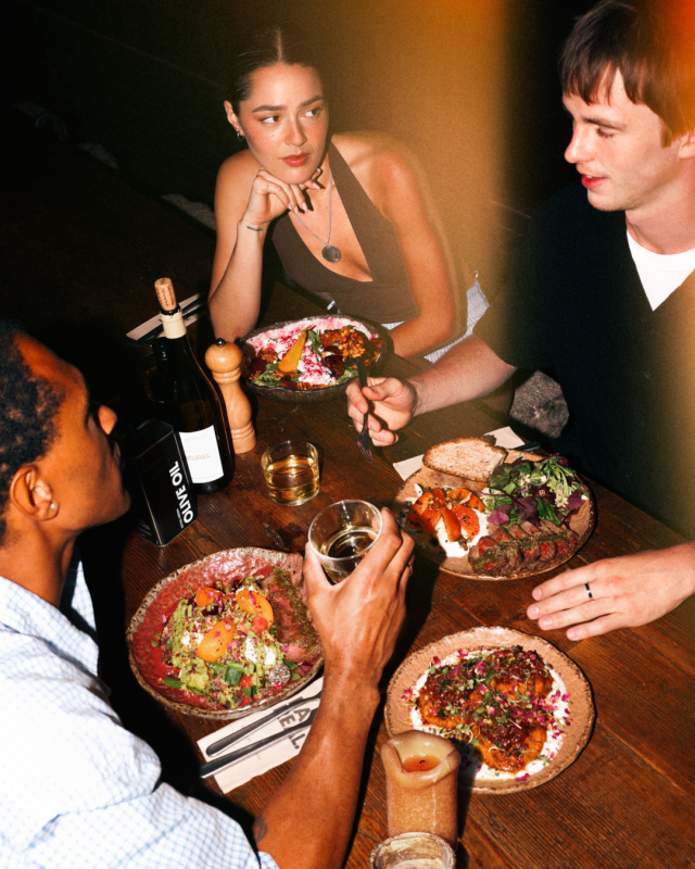 three people tucking into new summer menu at honest greens